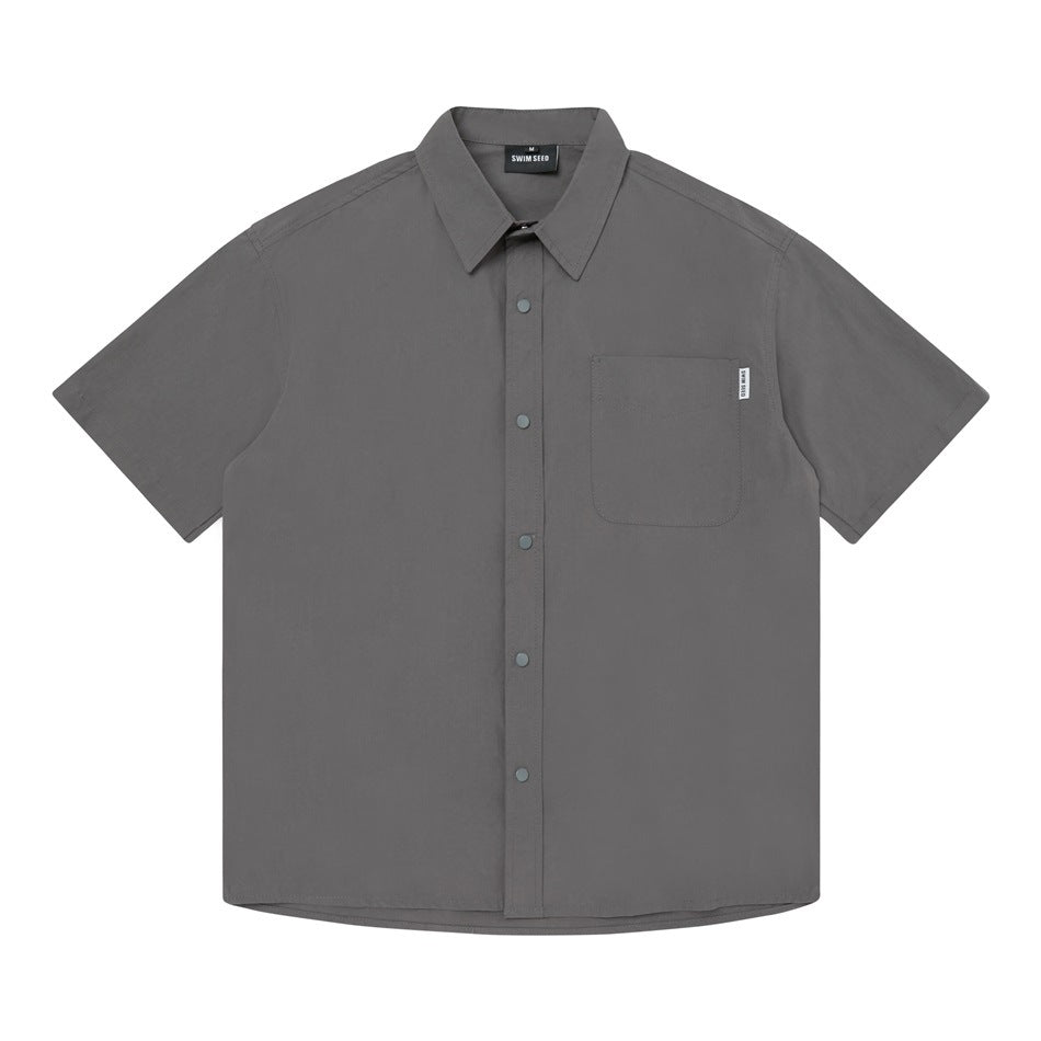 Front view of a gray short-sleeve button-up shirt with a pointed collar, snap buttons, and chest pocket.