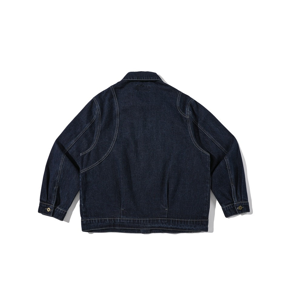 Back view of a dark indigo denim jacket with curved yoke seams, long sleeves, buttoned cuffs, and a straight hem.