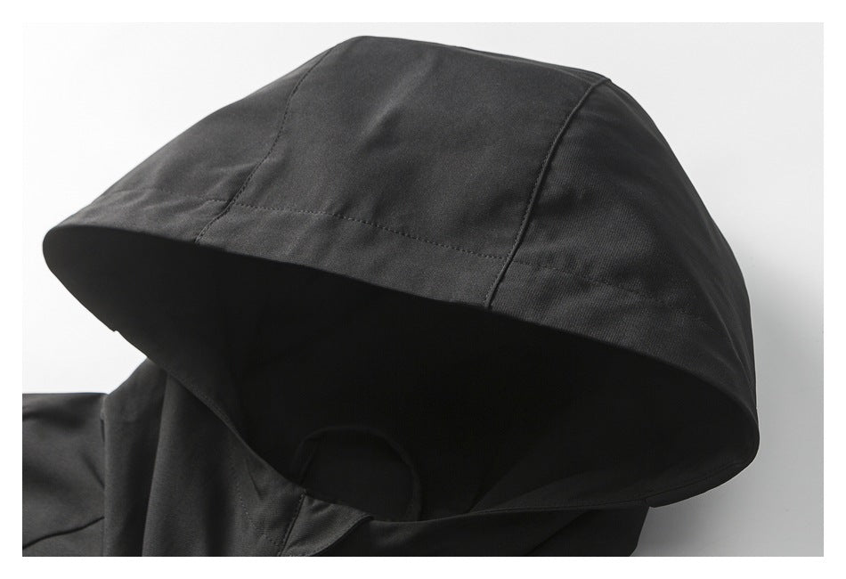 Close-up of the black jacket's hood, showing its panel seams and curved brim.