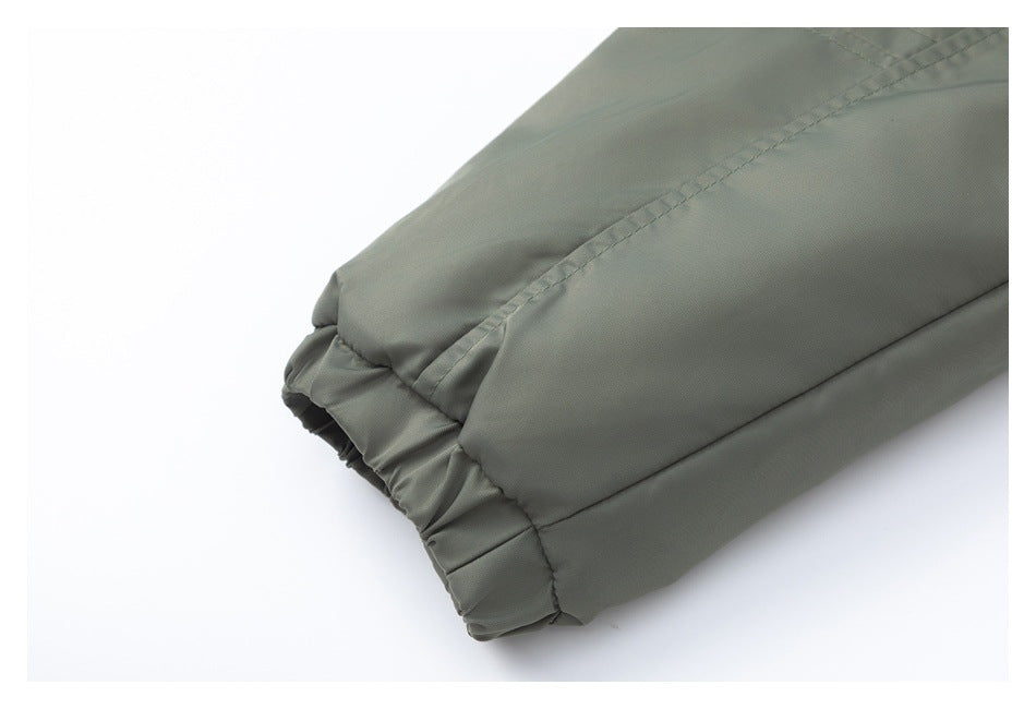 Close-up of a gathered elastic cuff on an olive-gray sleeve.