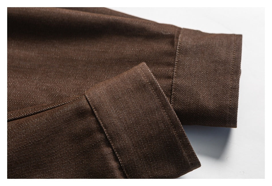 Close-up of a brown shirt sleeve and stitched cuff.