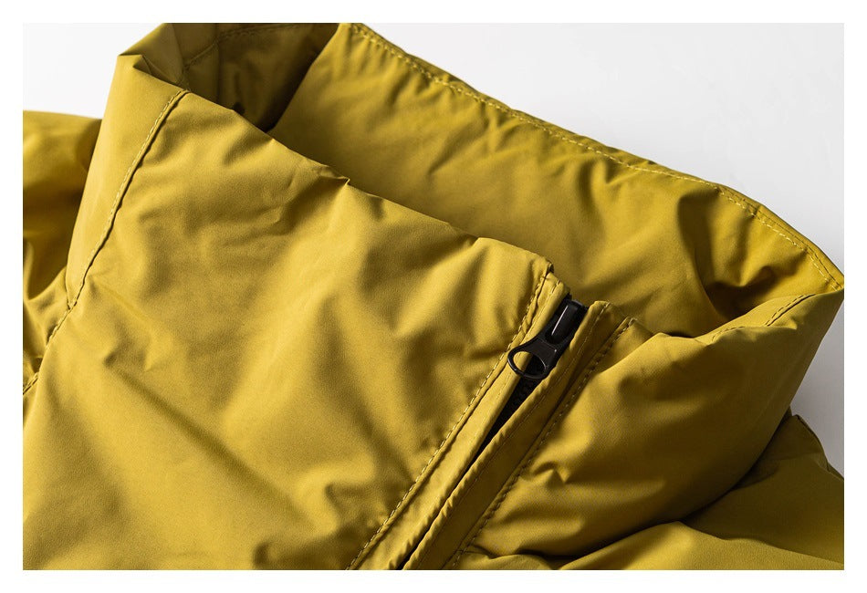 Close-up of a mustard yellow jacket collar and black zipper.