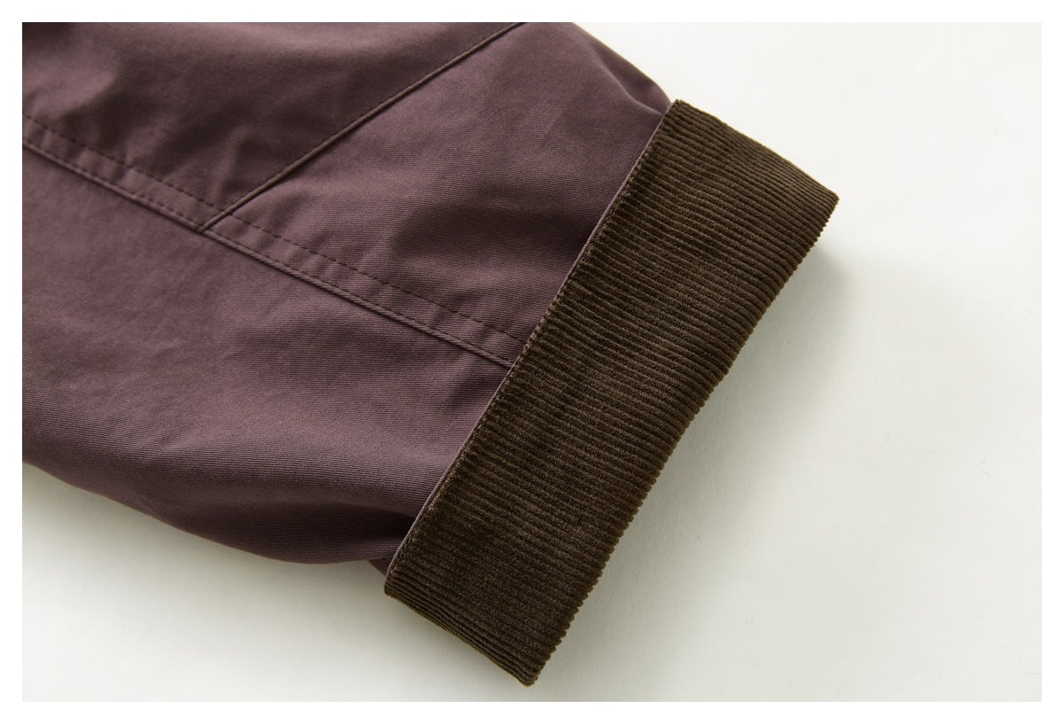 Close-up of a mauve-brown jacket sleeve ending in a wide dark brown ribbed cuff.