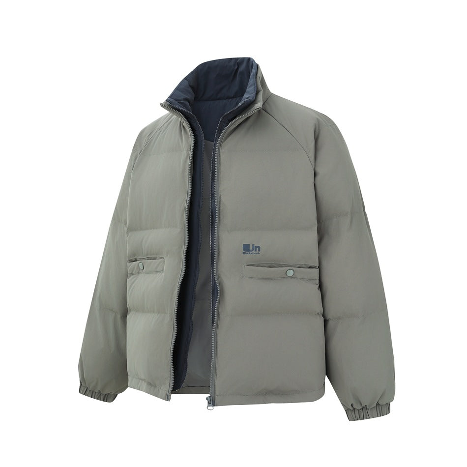 Gray-green puffer jacket angled with the outer zipper open, showing the navy inner zip layer and stand collar