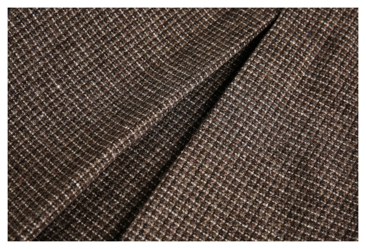 Close-up of brown and cream check fabric with a raised diagonal seam.