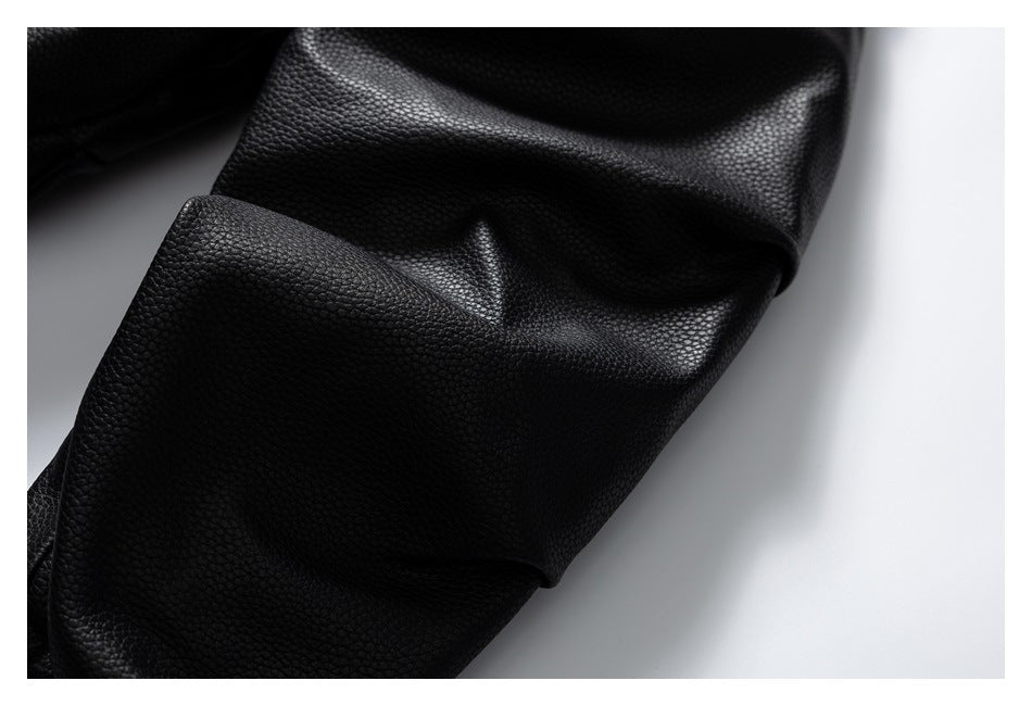 Close-up of a black pebbled jacket sleeve and its smooth stitched cuff.