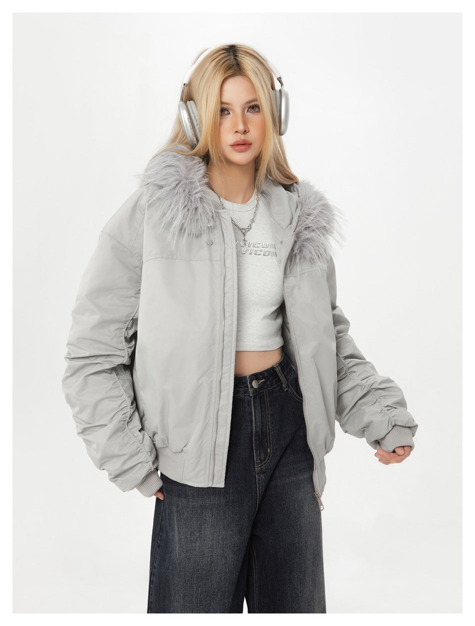 Model wearing an open light gray fur-collar jacket with dark jeans.