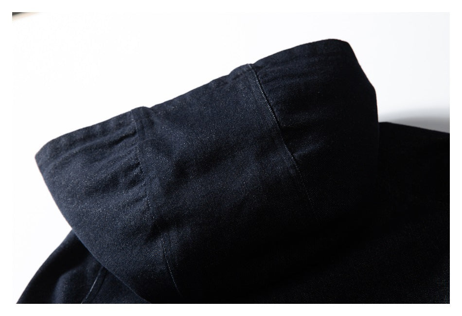 Close-up of the dark indigo jacket's folded collar and stitched seams.