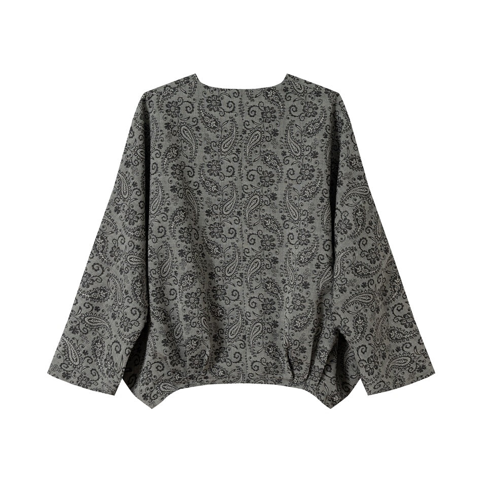 Front view of a gray long-sleeve jacket with an allover black floral paisley pattern and round neckline.