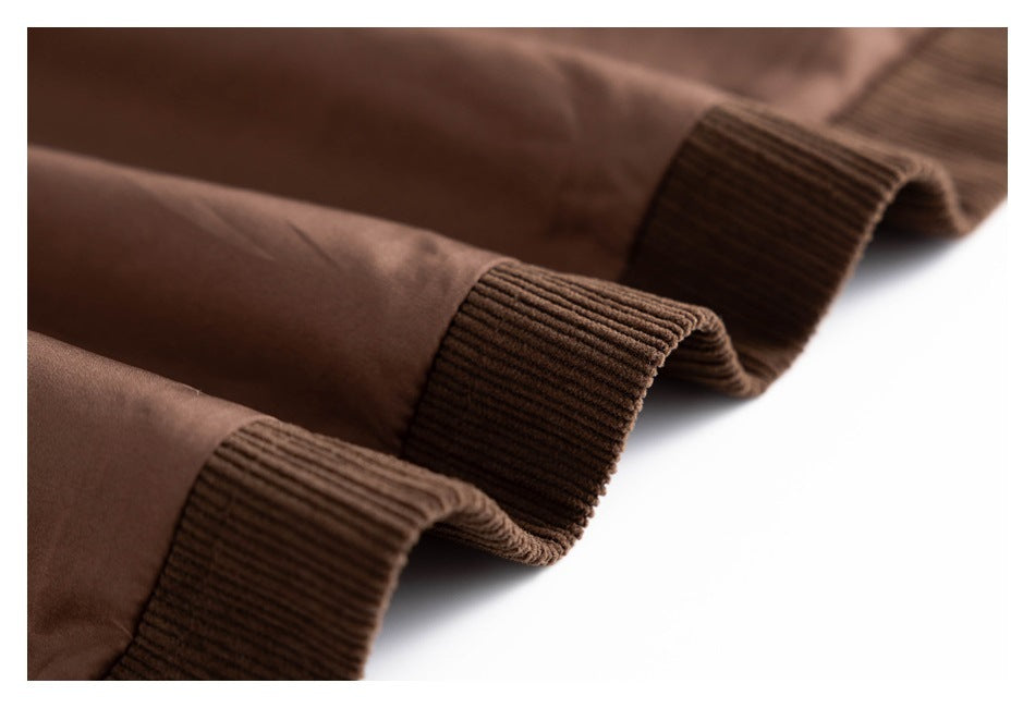 Close-up of brown garment sleeves showing wide ribbed corduroy cuffs.