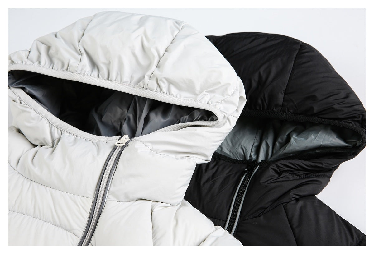 Close-up of white and black hooded puffer jackets showing the hood openings, lining, and front zippers.