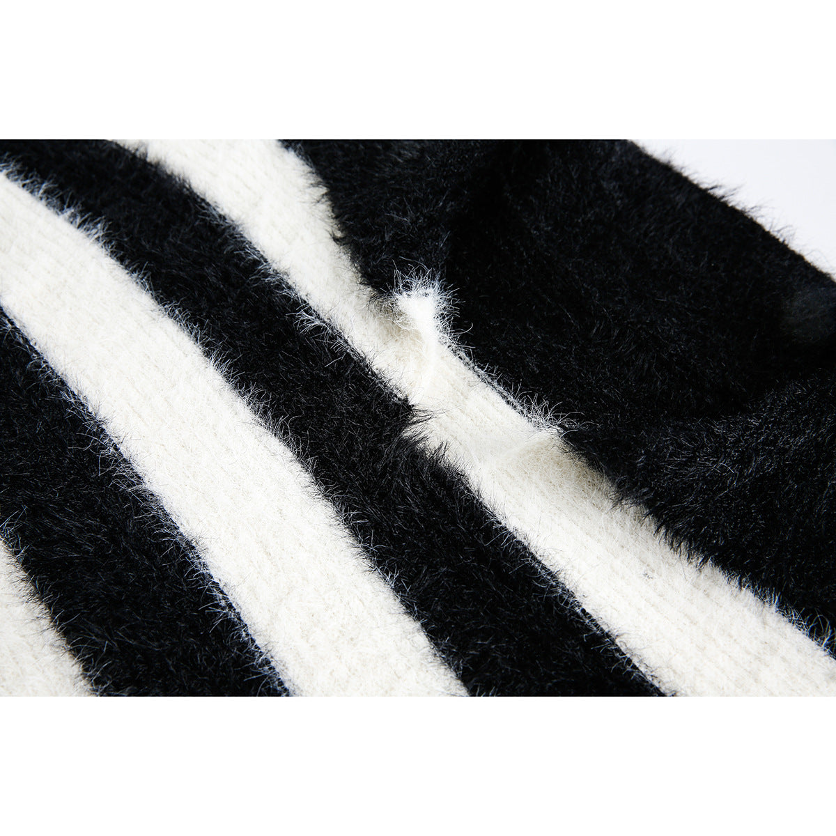 Close-up of fuzzy black-and-ivory striped knit fabric.