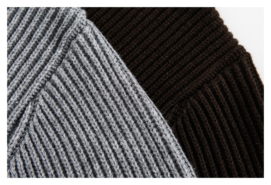 Close-up showing the rib-knit texture of gray and dark brown cardigan fabric.