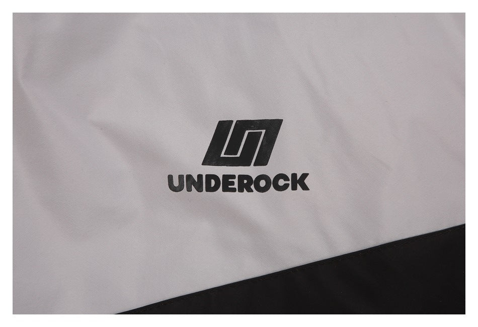 Close-up of black UNDEROCK logo printed on a light gray garment above a black panel.