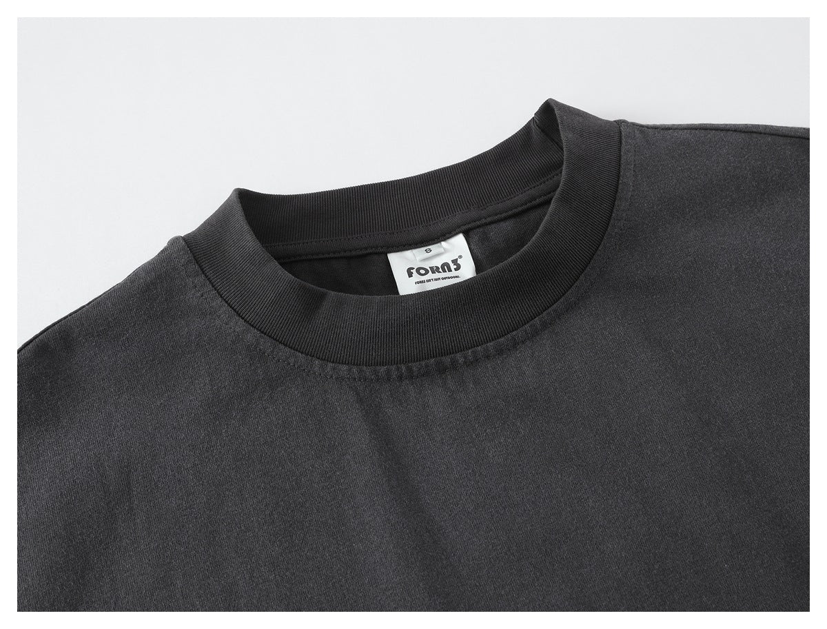 Close-up of the charcoal shirt's ribbed crew neck and sewn-in brand label.