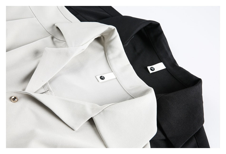 Close-up of the collars and inner labels of the white and black tunic colorways.