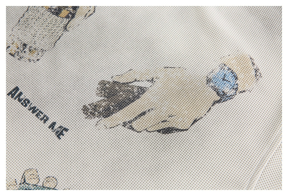 Close-up of a hand wearing a blue watch printed on cream textured knit fabric.