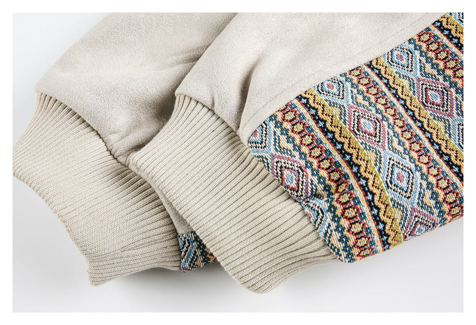 Close-up of beige jacket cuffs beside a colorful geometric patterned panel.