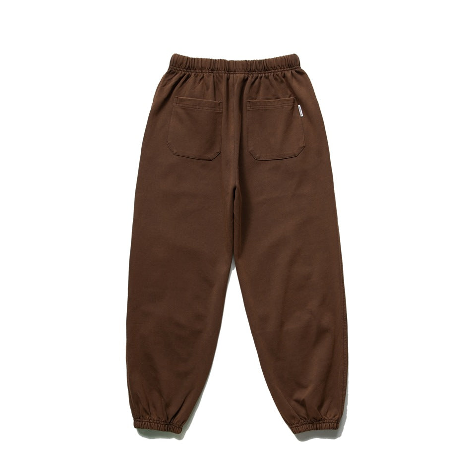 Back view of brown joggers with an elastic waist, two patch pockets, and elastic cuffs.