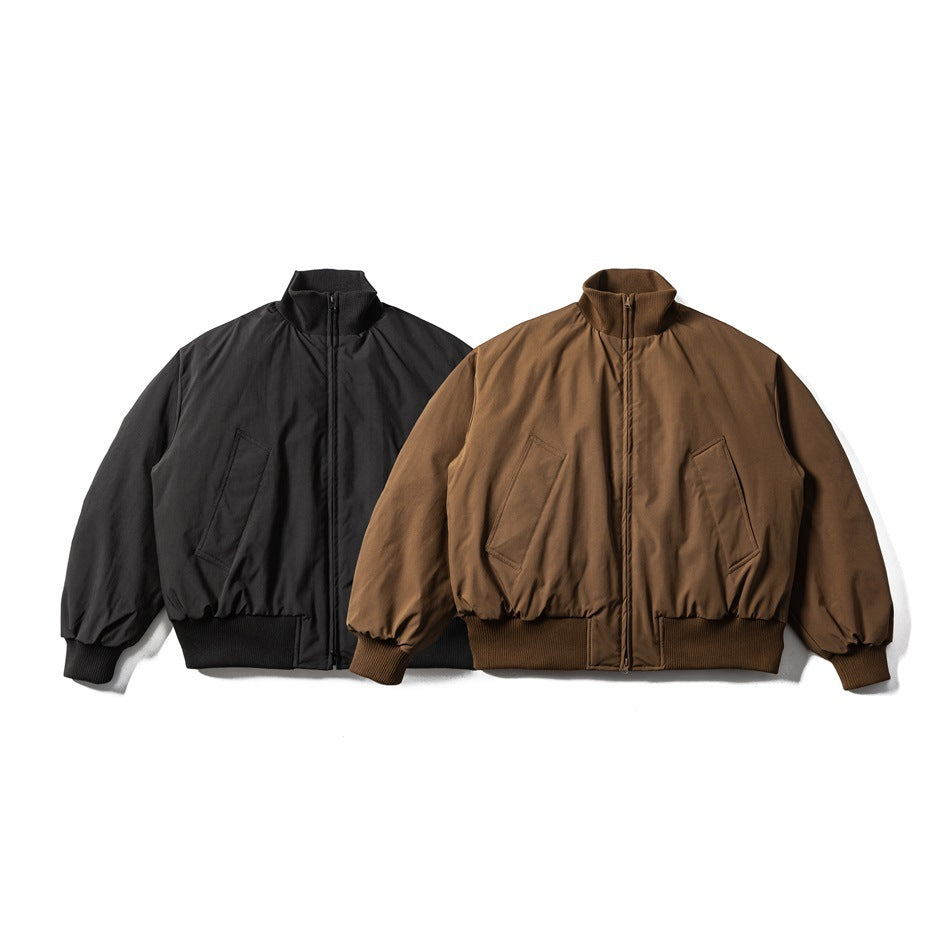 Two front-facing zip jackets shown side by side in black and brown, with stand collars and slanted pockets.