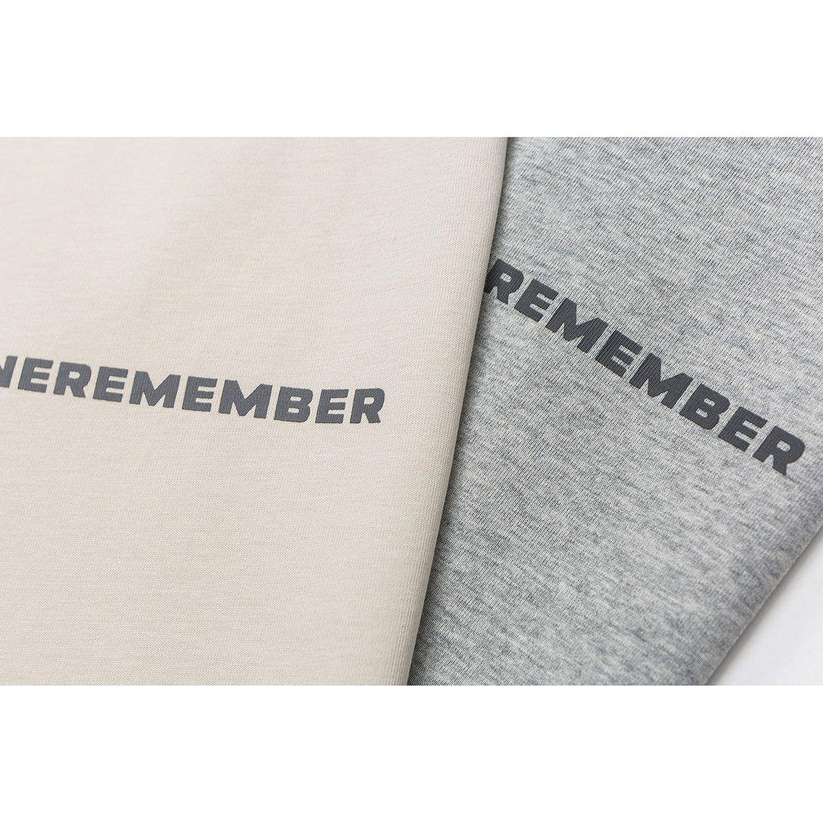 Close-up of dark lettering on cream and heather-gray fabric panels.