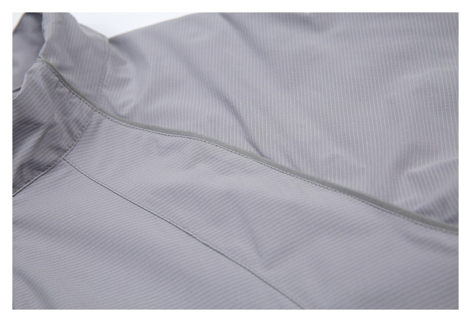 Close-up of gray finely striped fabric and curved stitched seam.