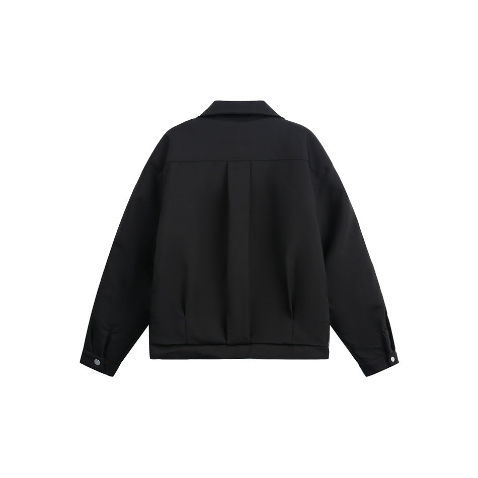 Back view of a black jacket with a center pleat, pointed collar, and buttoned cuffs.