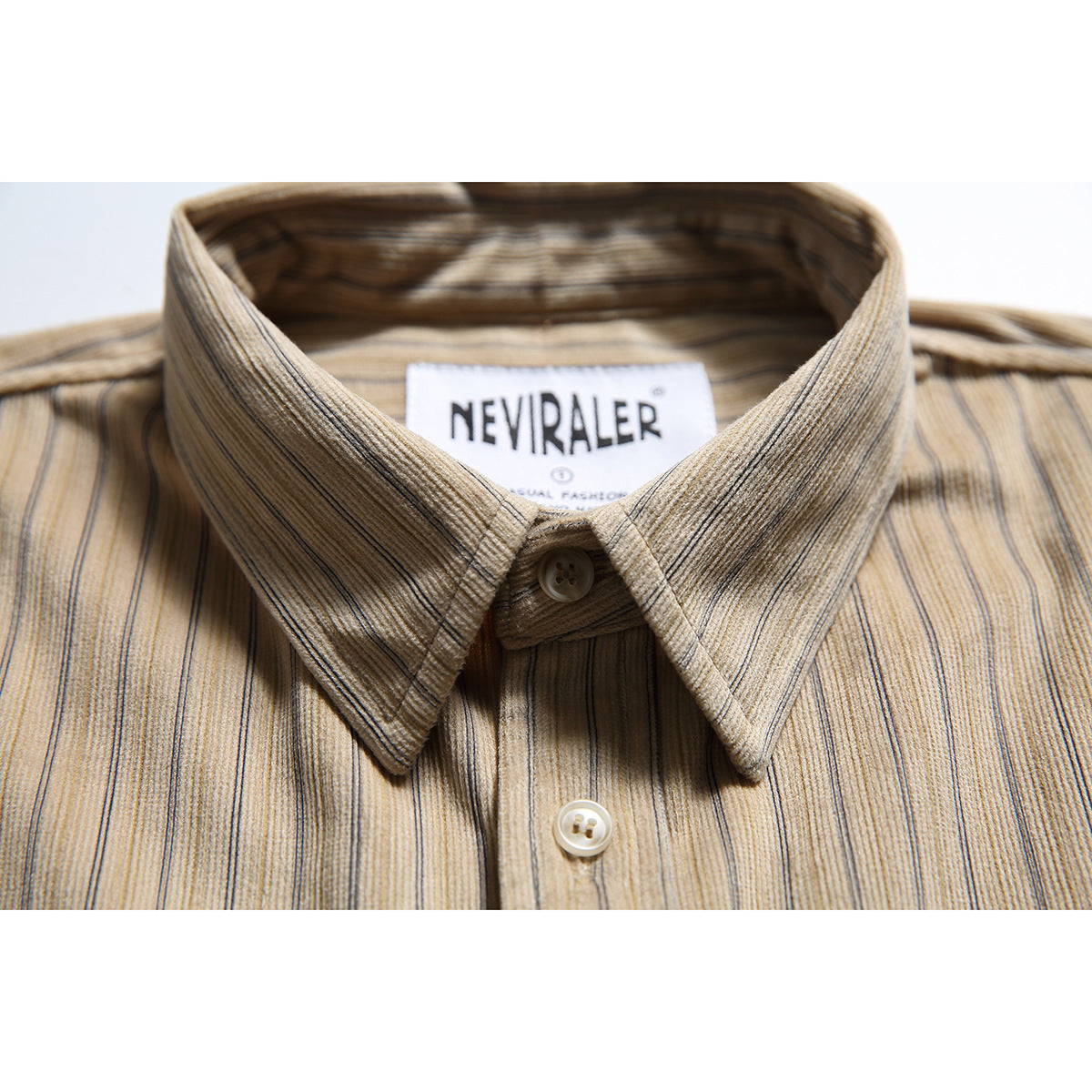 Close-up of a beige shirt collar and buttons with fine vertical stripes.