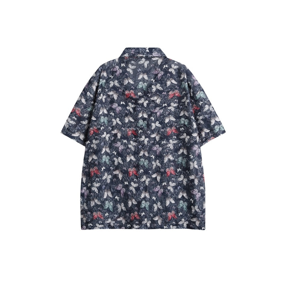 Back view of a navy short-sleeve button-up shirt with a multicolored butterfly print.
