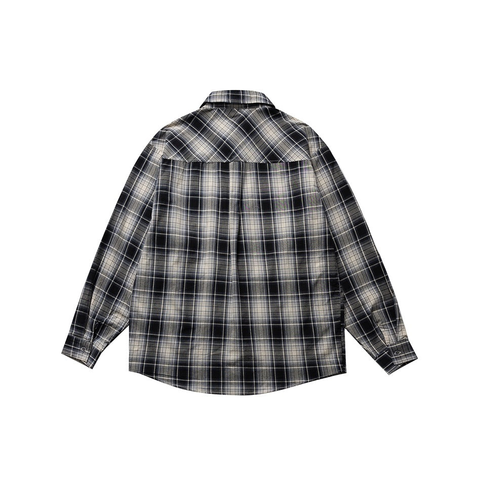 Back view of gray, black and cream plaid long-sleeve shirt with back yoke seam and button cuffs