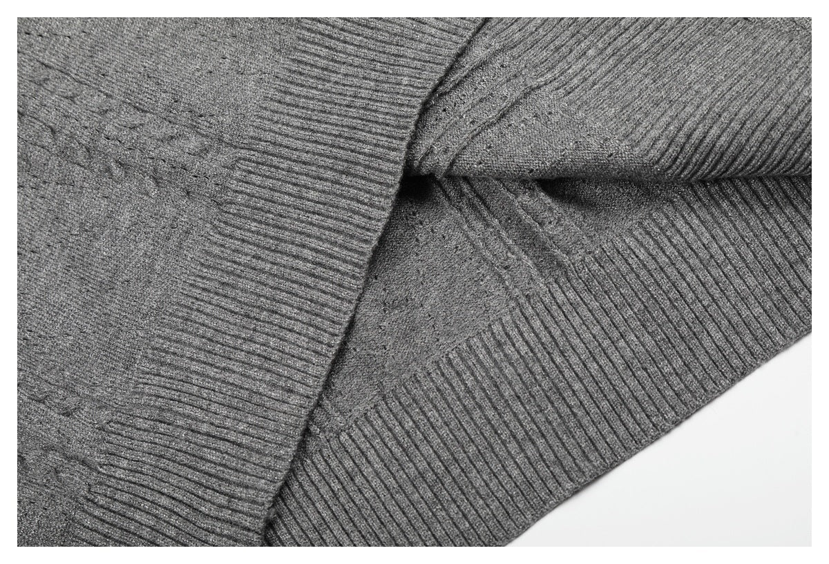 Close-up of the gray knit top's ribbed edges and seams, with part of the garment folded over.