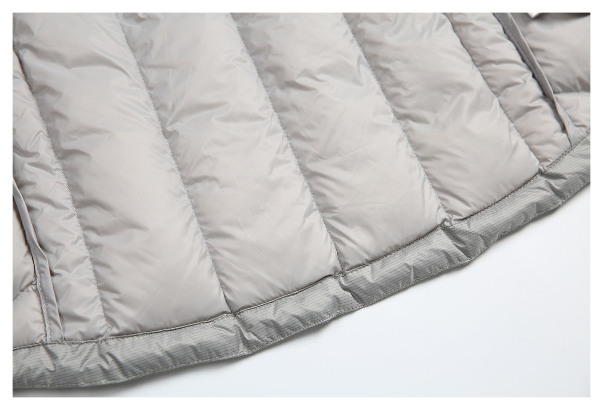 Close-up of the light gray jacket's quilted panels and striped lower trim.