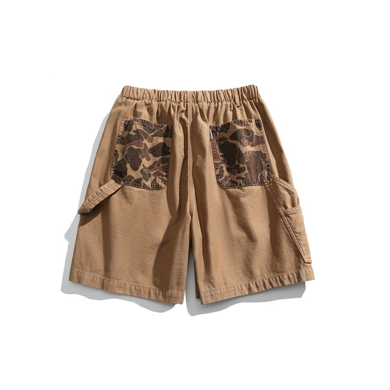 Rear view of tan shorts with an elastic waistband, camouflage-print patch pockets, and side cargo pockets.