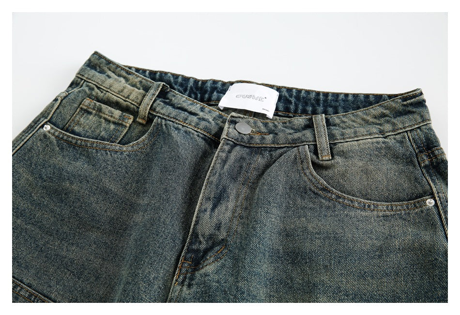 Close-up of the shorts' faded denim front, waistband, button, belt loops, and pockets.