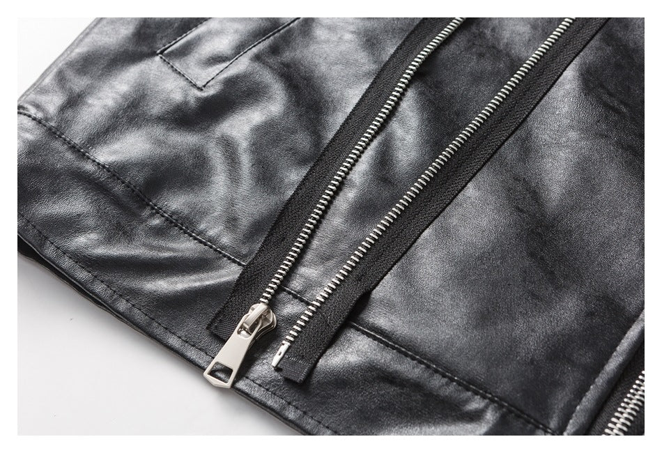 Close-up of a black jacket showing a silver front zipper and a narrow zippered pocket.