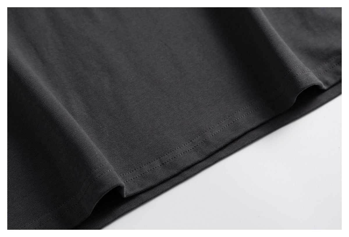 Close-up of the charcoal T-shirt's double-stitched bottom hem.