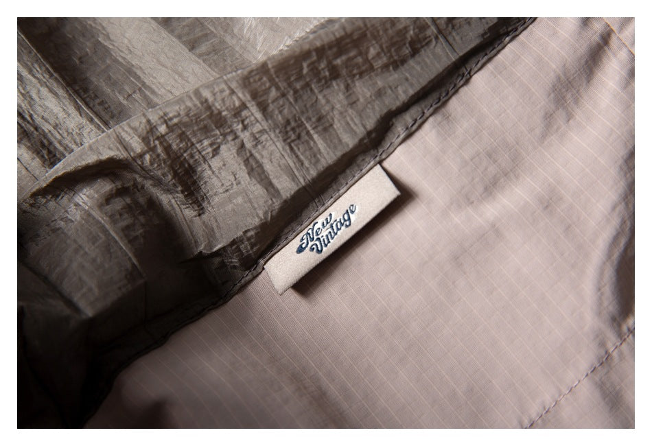 Close-up of taupe fabric with a sewn label reading “New Vintage.”