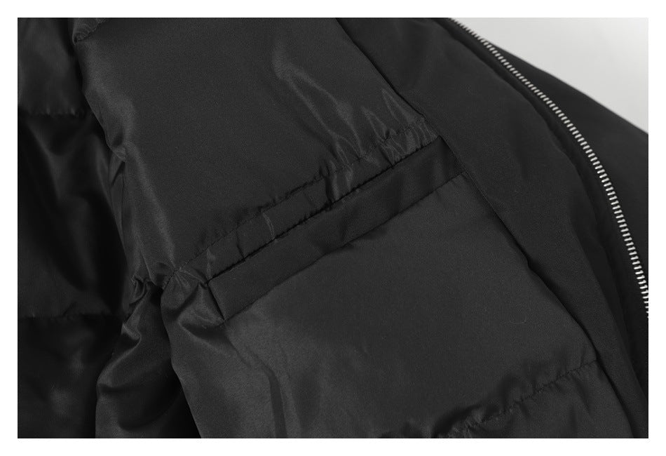 Close-up of a black jacket's interior pocket area and silver zipper edge.