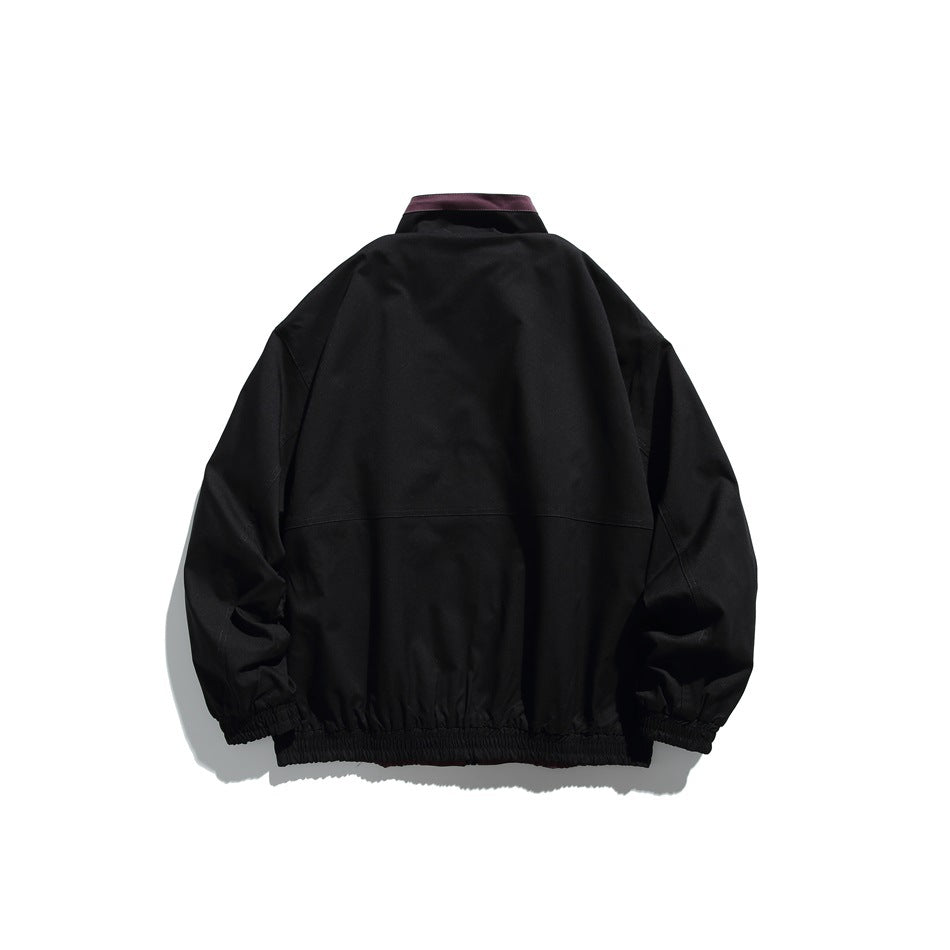 Back view of a black jacket with a plum collar accent, a horizontal upper-back seam, and elastic cuffs and hem.