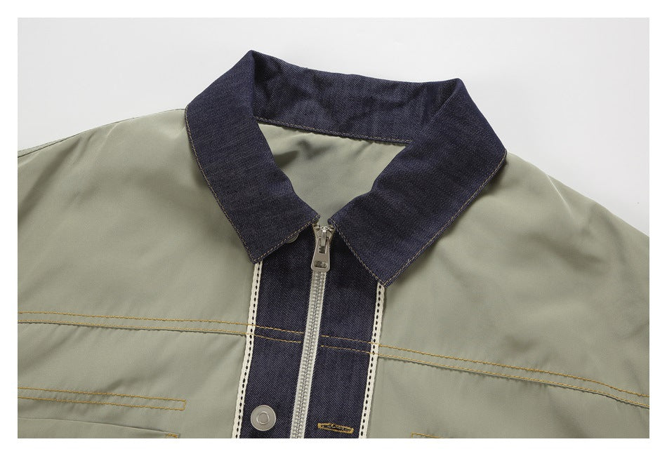 Close-up of the olive jacket’s dark denim collar and zip-front placket with contrast stitching.