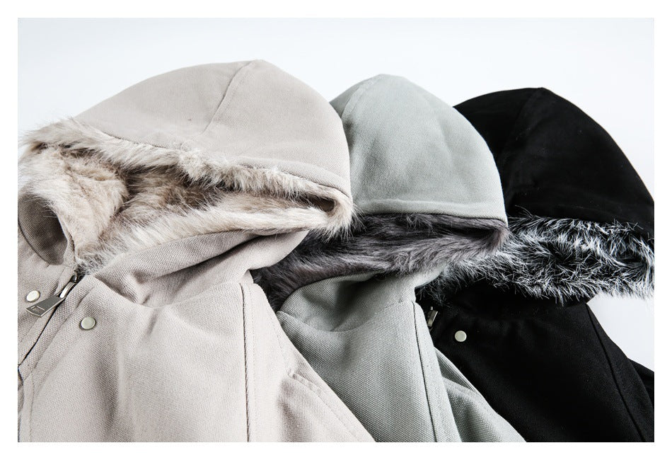 Close-up of beige, pale gray, and black hooded jackets showing their faux-fur linings and upper fronts.