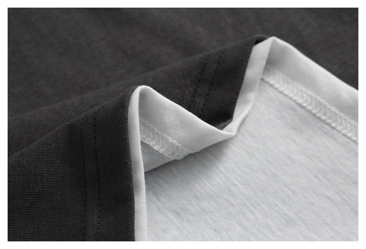 Close-up of the charcoal shirt's folded edge and white interior seam stitching.