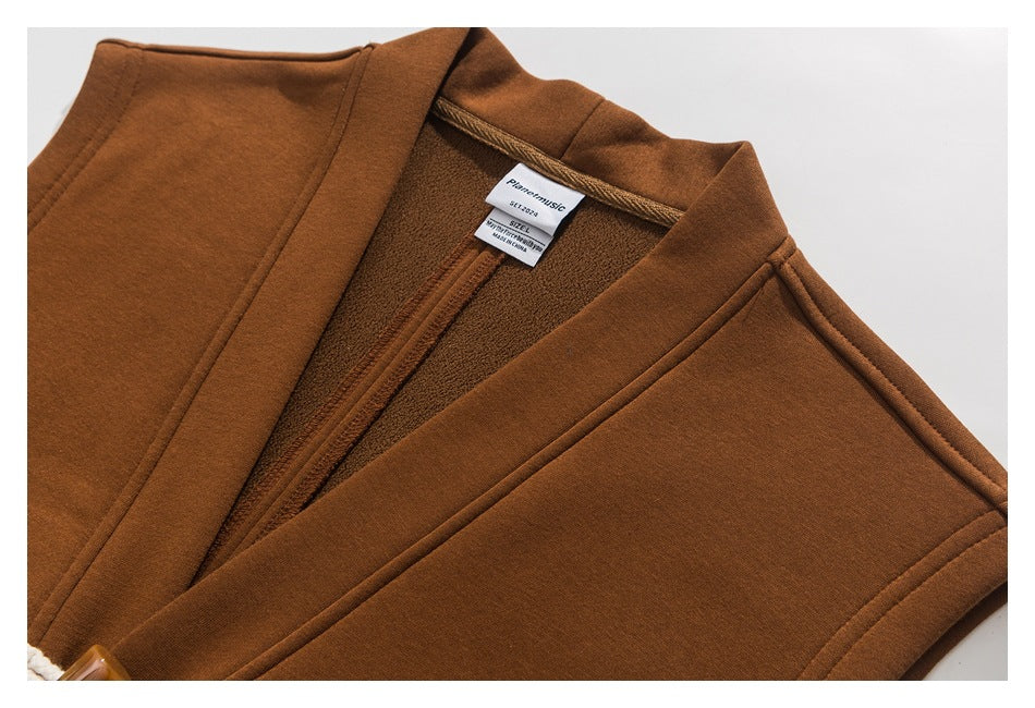 Close-up of a rust-brown coat's collar, inner lining, and sewn-in neck label.