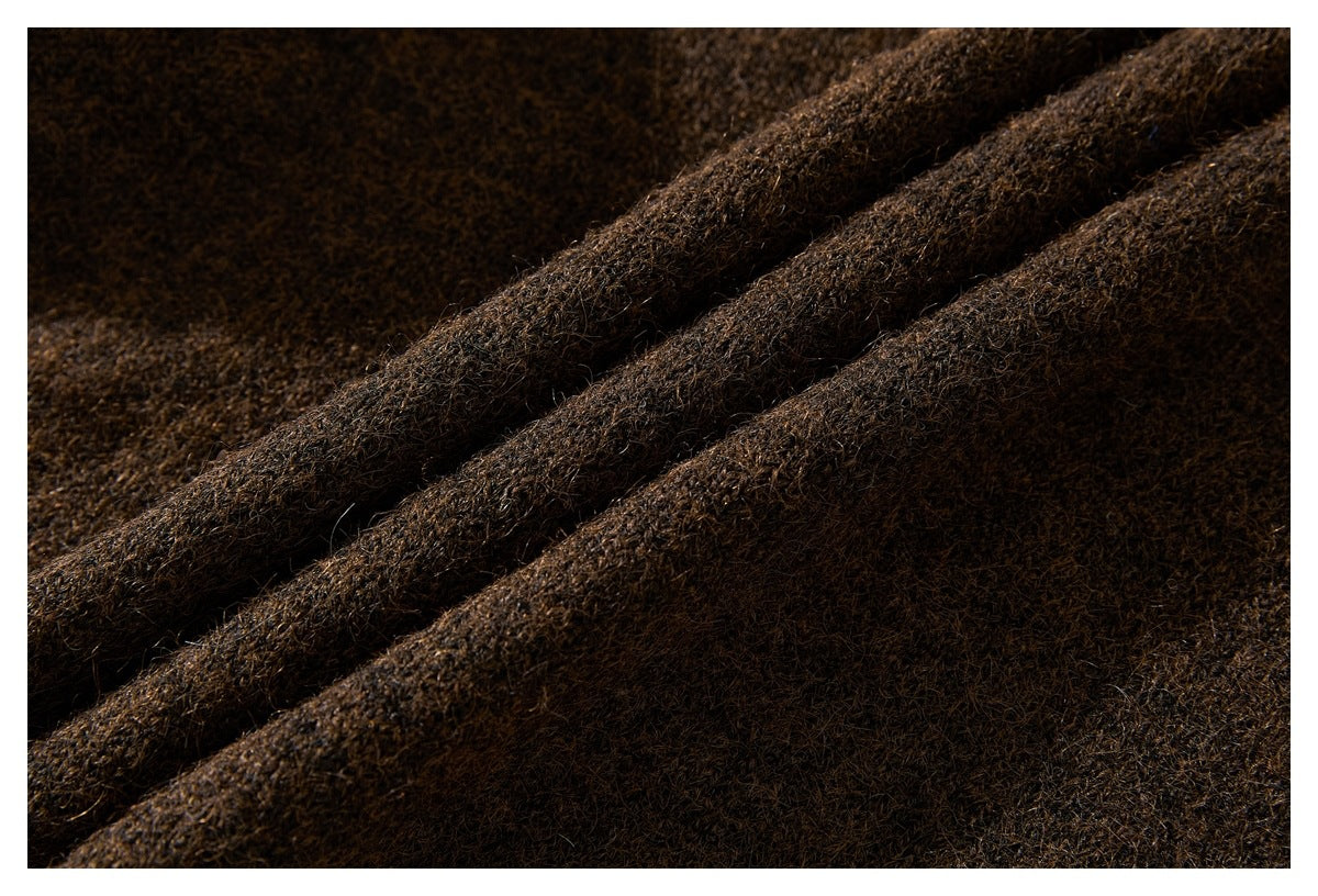 Close-up of dark brown knit fabric arranged in soft folds.