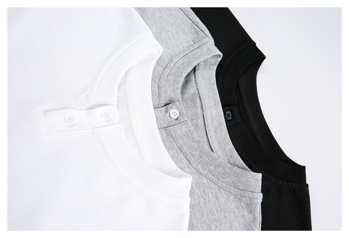 Close-up of the two-button henley necklines on white, gray, and black T-shirts.
