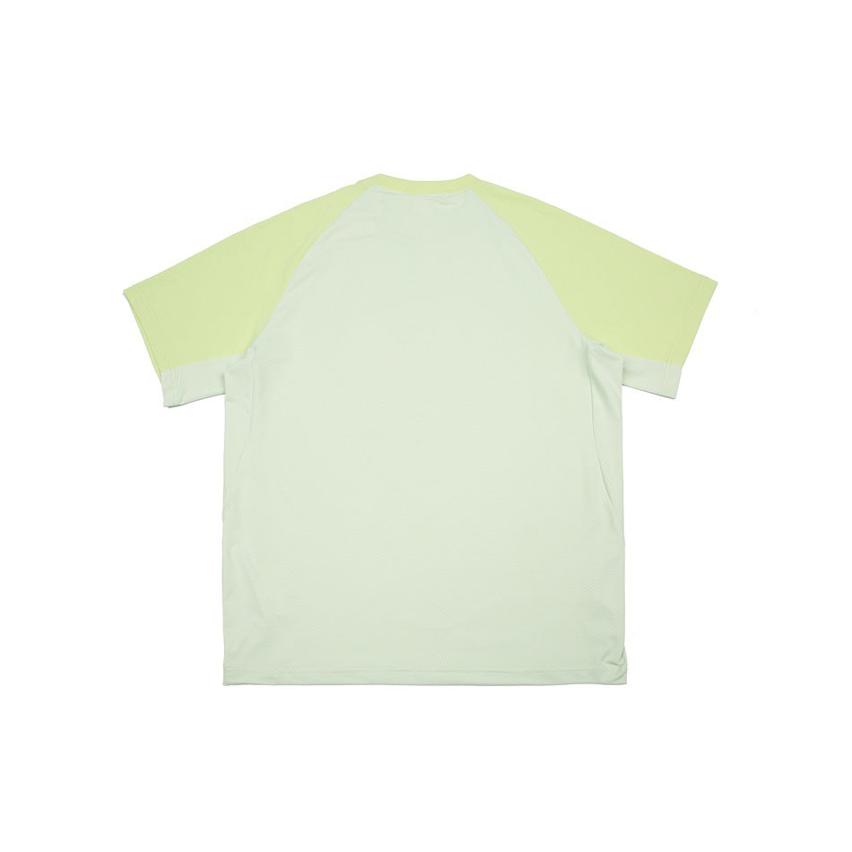 Back view of a pale mint shirt with a light body, lime-green raglan sleeves, and contrasting side panels.