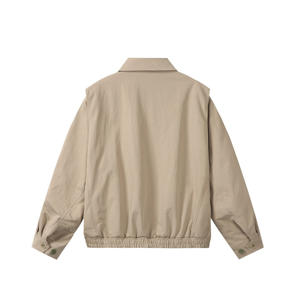 Back view of a khaki jacket showing the collar, back seams, elastic hem and buttoned cuffs