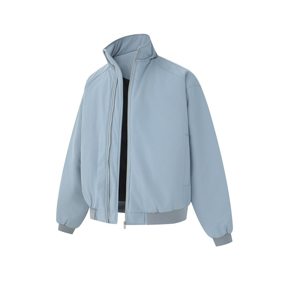 Pale blue zip-front jacket with a tall stand collar, long sleeves, and gray ribbed cuffs and hem, shown from the front.