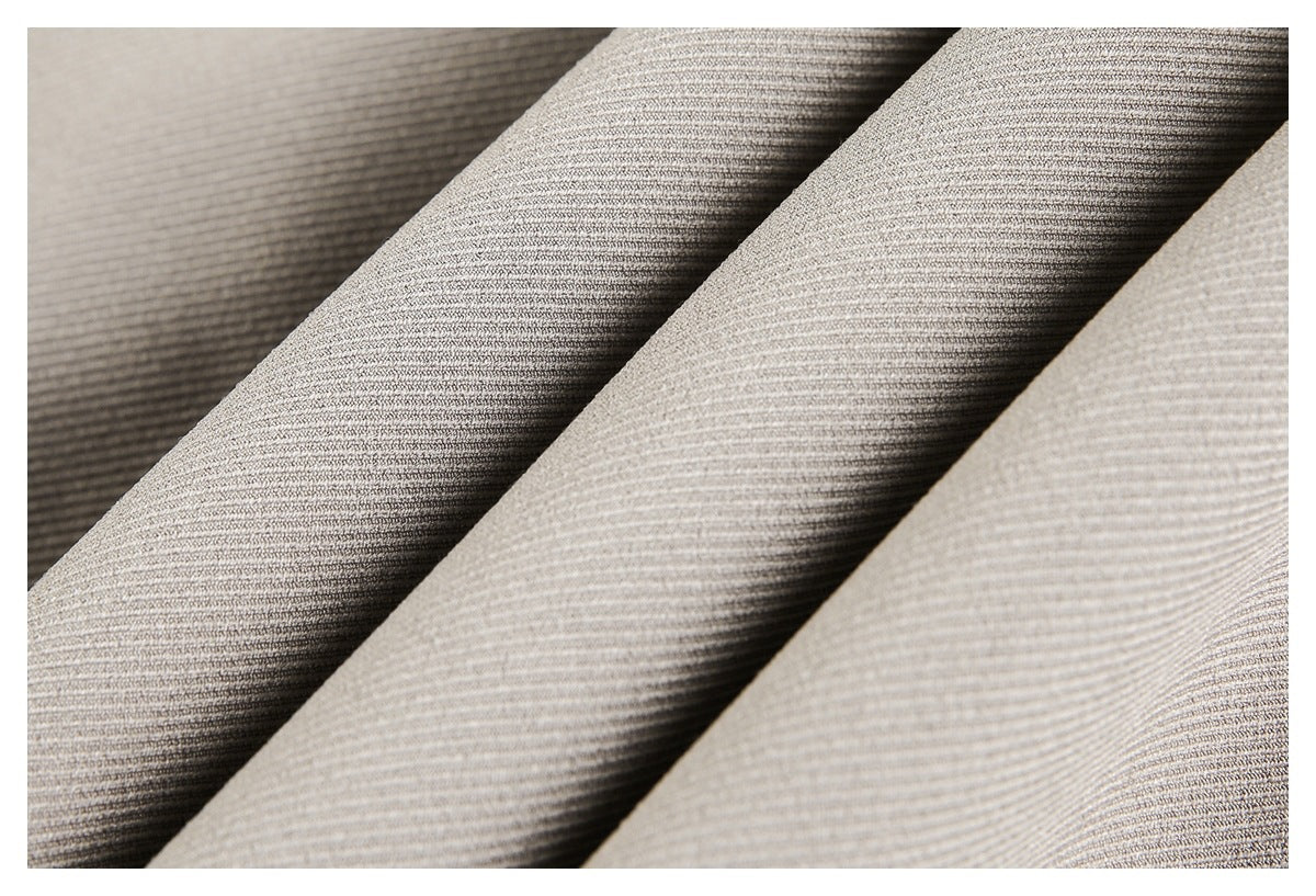 Close-up of taupe jacket fabric draped in folds, showing its fine textured weave.