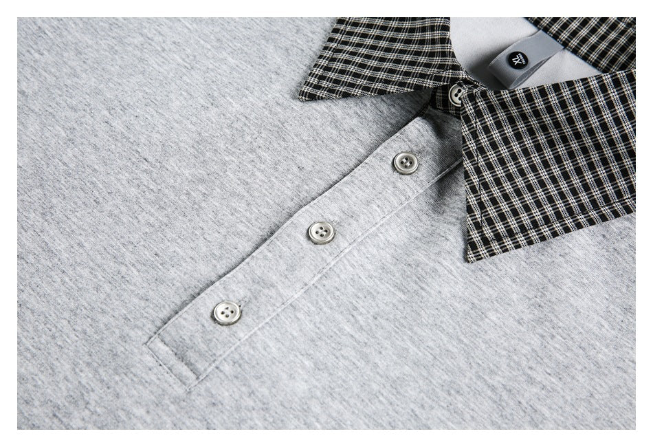 Close-up of a gray top's three-button placket and black-and-white checked collar.